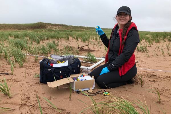 Brianna Lunardi taking samples of the sand and vegetation in Stanhope on the island’s north shore.