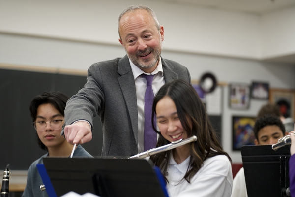 Brian Zanier indicates point on musical score to flautist