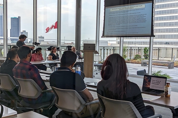 people in classroom look at slideshow presentation