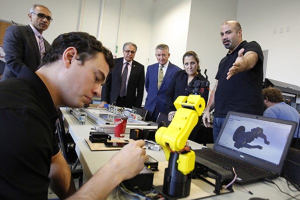 Michael Elachkar, a skilled trades professional enrolled in the university’s BEng Tech program, shows Canadian Minister of Foreign Affairs Chrystia Freeland how the class is working with programmable logic controllers to improve industrial automation.
