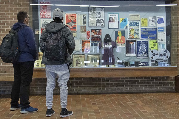 Students look at a display of CJAMfm memorabilia in the Leddy Library lobby.