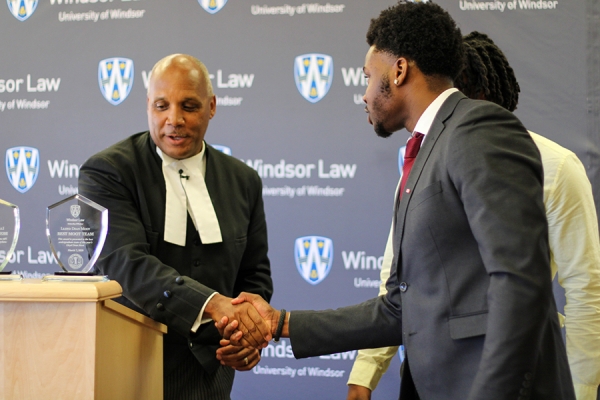 Justice Lloyd Dean shaking students&#039; hands
