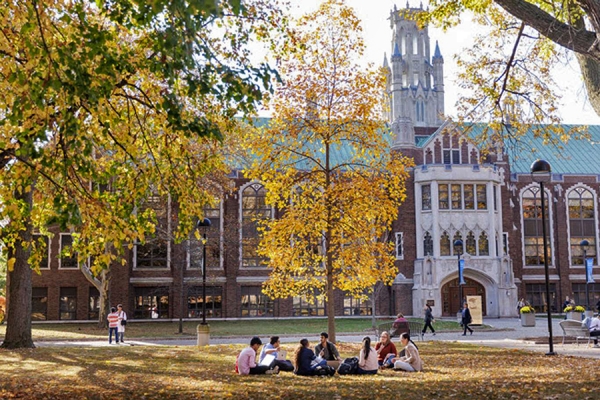 students sitting on lawn outside Dillon Hall