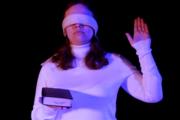 blindfolded woman taking oath