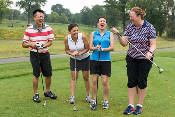 foursome of golfers laughing