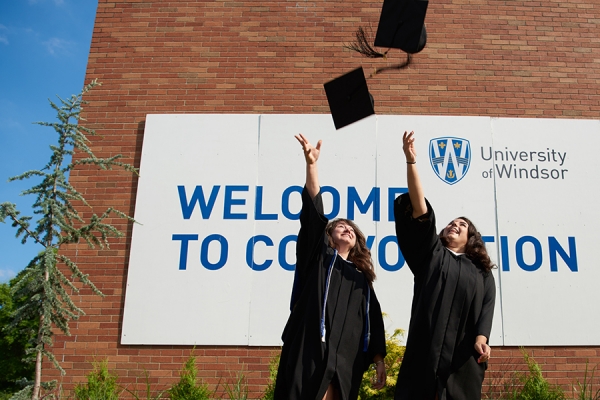 grads tossing caps in air