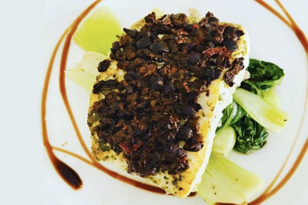 Filet of halibut surrounded with balsamic glaze