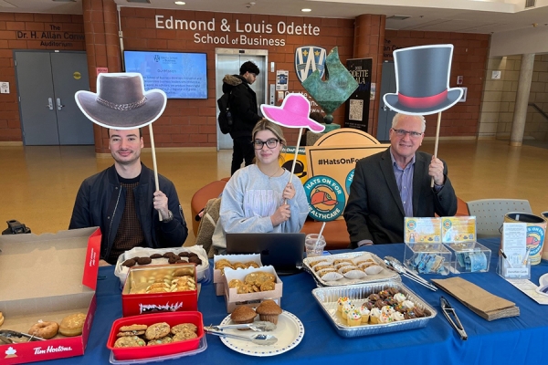 Nicolas Lacroix-Pouliot and Jovana Saric and dean Mitch Fields selling baked goods