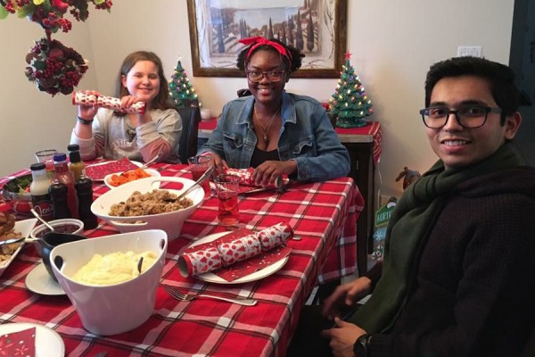 students joining family at dinner table