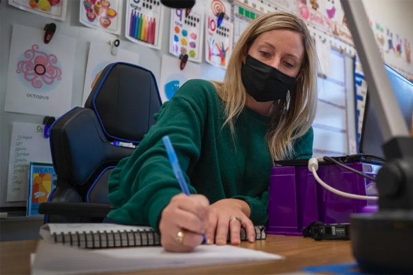 Teacher working in hybrid classroom