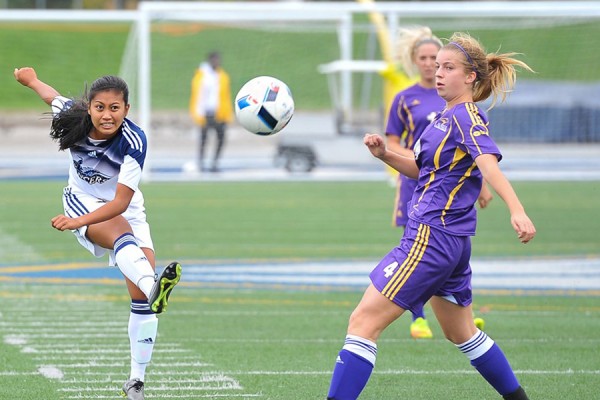 Windsor midfielder Jade Samping puts boot to ball in action against Laurier.