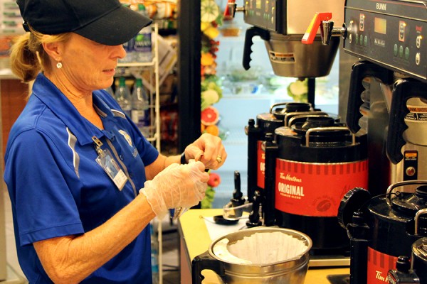 Food Services worker filling Tim Hortons percolator