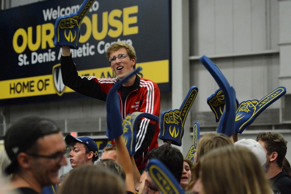 cheering student held up by peers