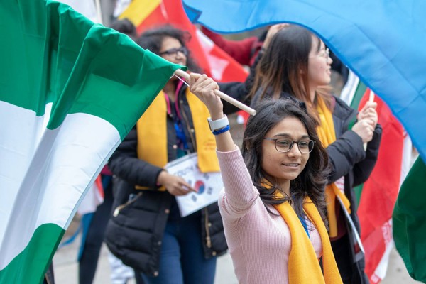 International students carrying flags of many countries