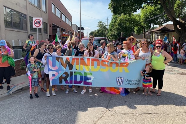 marchers hold banner reading UWindsor Pride