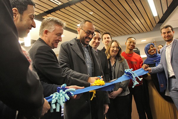 UWindsor students and officials cut a ribbon.