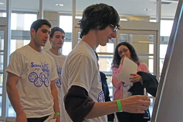 Assumption catholic high school students raced to finish a science pictionary challenge in Science Olympiad.