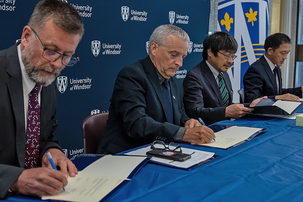 Officials signing documents