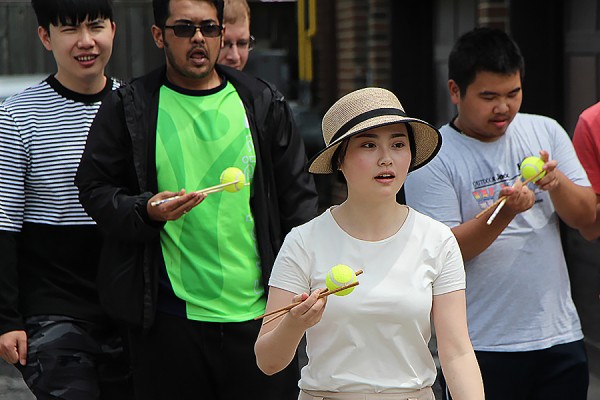 Stella Jiang holds a ball with chopsticks in the first leg of the Trivia Tower Race, one of the activities held Friday for World Student Day.