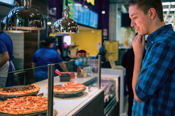 student looking at pizza