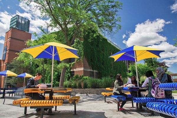 students seated at tables in Student Courtyard