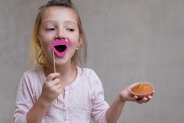 small child holding cupcake