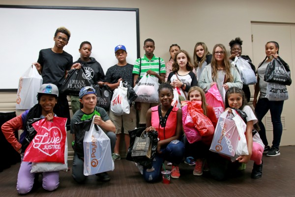 Participants of United Way&#039;s On Track To Success pose with their purchases at Devonshire Mall on Thursday, Aug. 24, 2017.