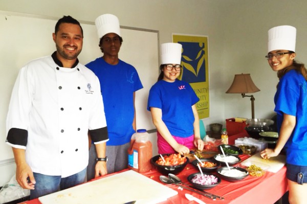 From left to right: At Libro Community Café’s recent event, Executive Chef Paolo Vasapolli, worked with Balal Mohamed, Vivian Hui and Veronica Miller to prepare fish tacos with pickled red cabbage, and served the meals to the community. 