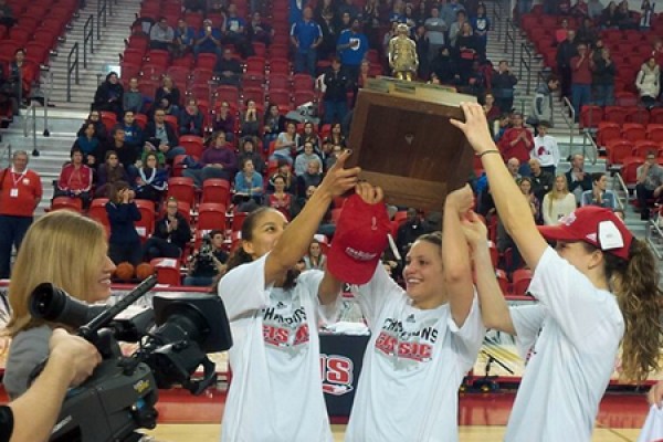 members of the Lancer women’s basketball team hoist the Bronze Baby trophy