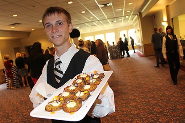 server holding platter of fritters