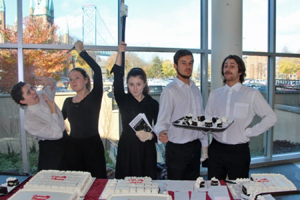 acing students cut cake with an axe