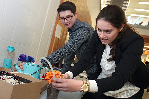 Donovan O’Donnell and Claudia Lutfallah prepare their automated plant watering system for judging.