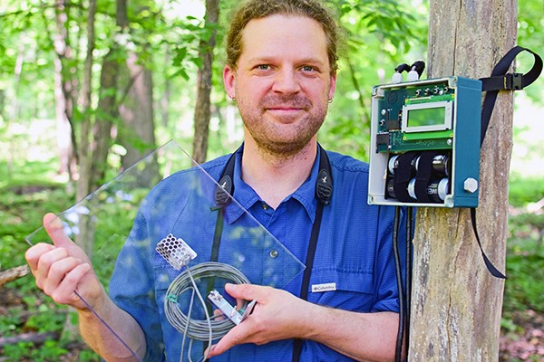 Biology professor Dan Mennill displays some of the sonic equipment used to track birds migrating at night.