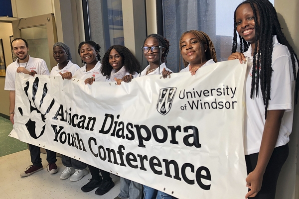 Student organizers hold the banner of the African Diaspora Youth Conference