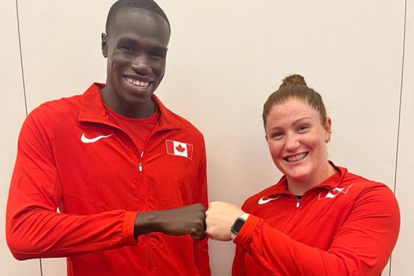 Team Canada captains Marco Arop and  Sarah Mitton bump fists