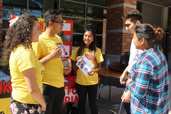 Representatives of the Caring for Cambodia club try to recruit some new members during Club Days activities Monday.