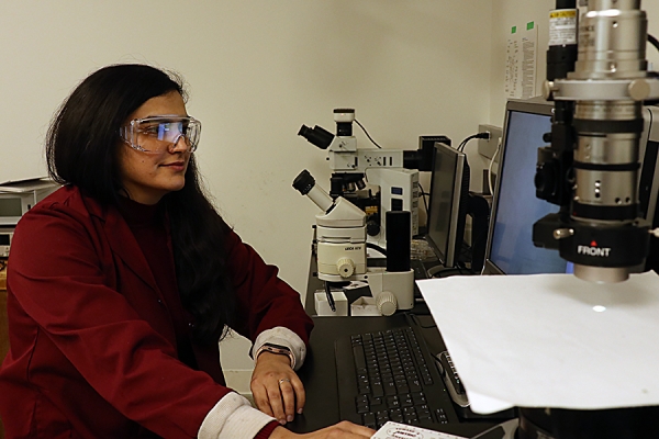 Fatemeh Motaghedi working on chemistry lab equipment