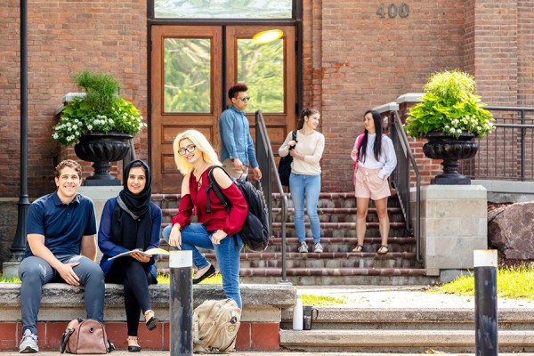 students posed outside Assumption Hall