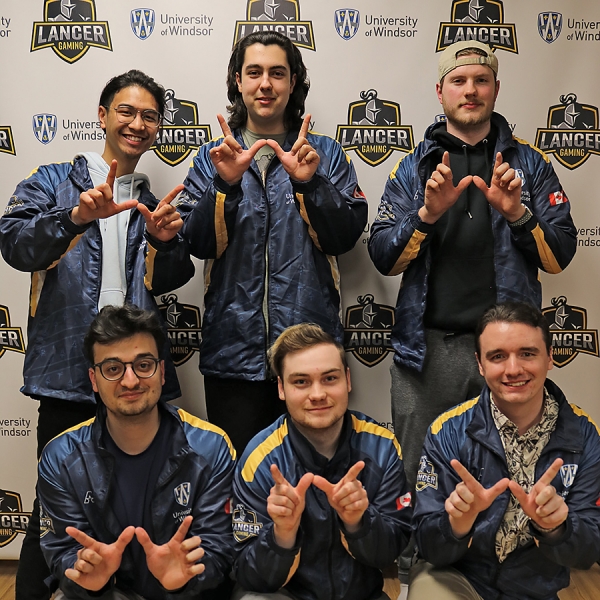 Members of the Lancer League of Legends team form their fingers into Ws