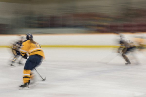 photo by Cyndra MacDowall of women playing hockey