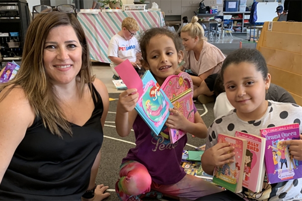 Melissa Caschera with kids holding books