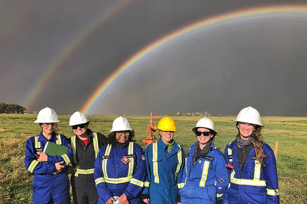 students standing under rainbow
