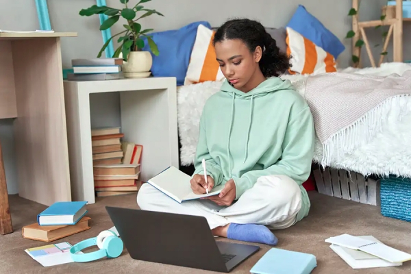 Young woman working on laptop computer.