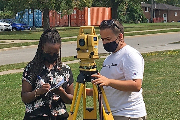students working with surveying equipment