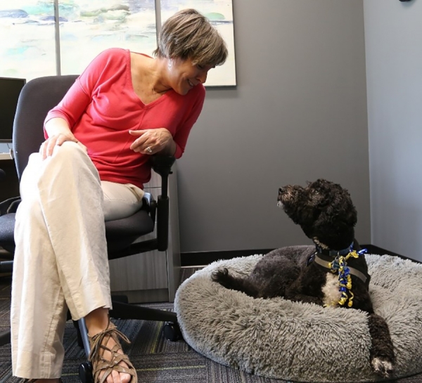 Giselle St. Louis, clinical therapist in the Faculty of Engineering and therapy dog Winnie, a standard poodle