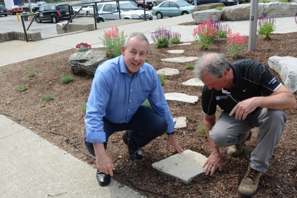 Athletic director Mike Havey placed a paving stone representing his department’s 100 percent participation in the perennial garden outside the Leddy Library during a donors appreciation reception, Thursday.