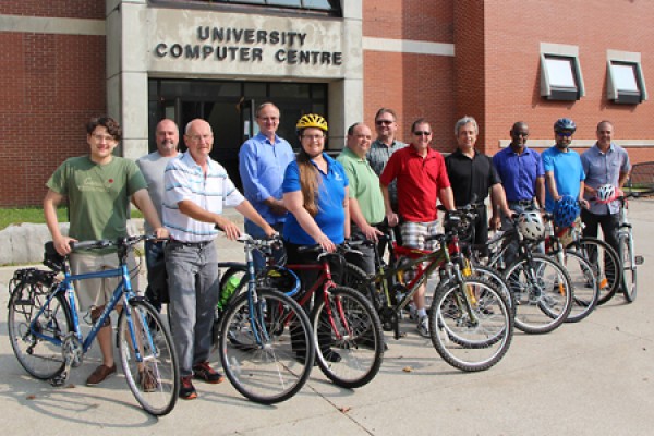 bikers pose in front of the University Computer Centre