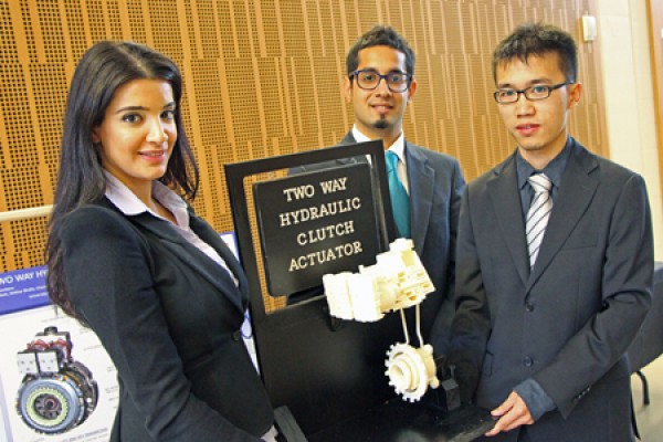 Suzan Matti, Shikhar Bhalla and Chau Yi Miao display a model of their clutch actuator design.