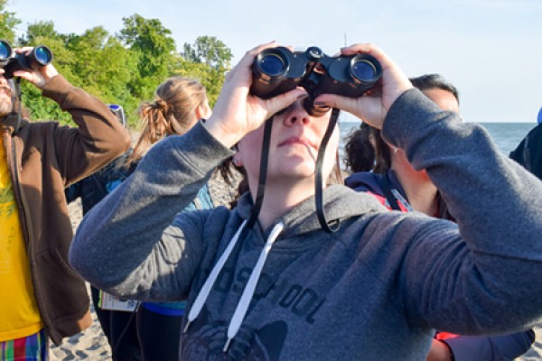 Erica Authier looks through binoculars