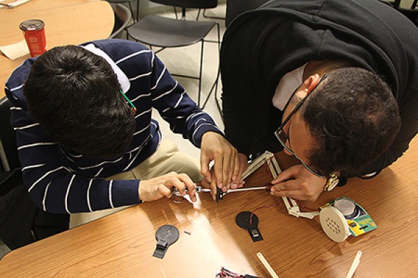 Humoud Alhumoud and Khalid Alharbi make last-minute adjustments to their USB lamp